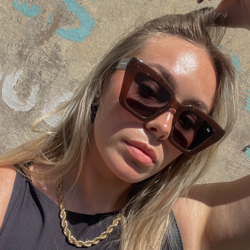 Woman street style wearing brown shimmer square oversized polarised Bored George sunglasses