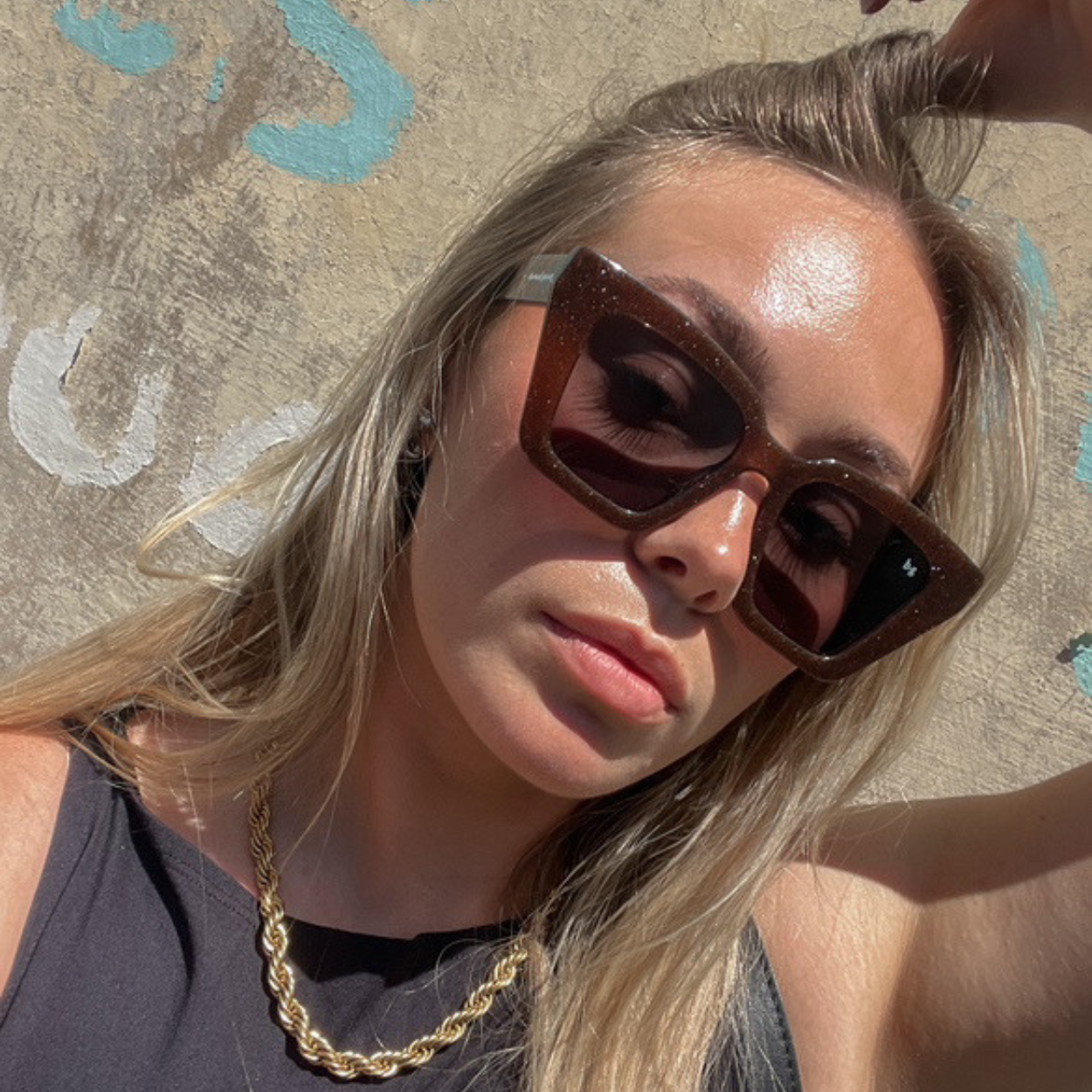 Woman street style wearing brown shimmer square oversized polarised Bored George sunglasses