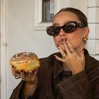 Close up of woman in brown outfit wearing polarised espresso chocolate oval Bored George sunglasses